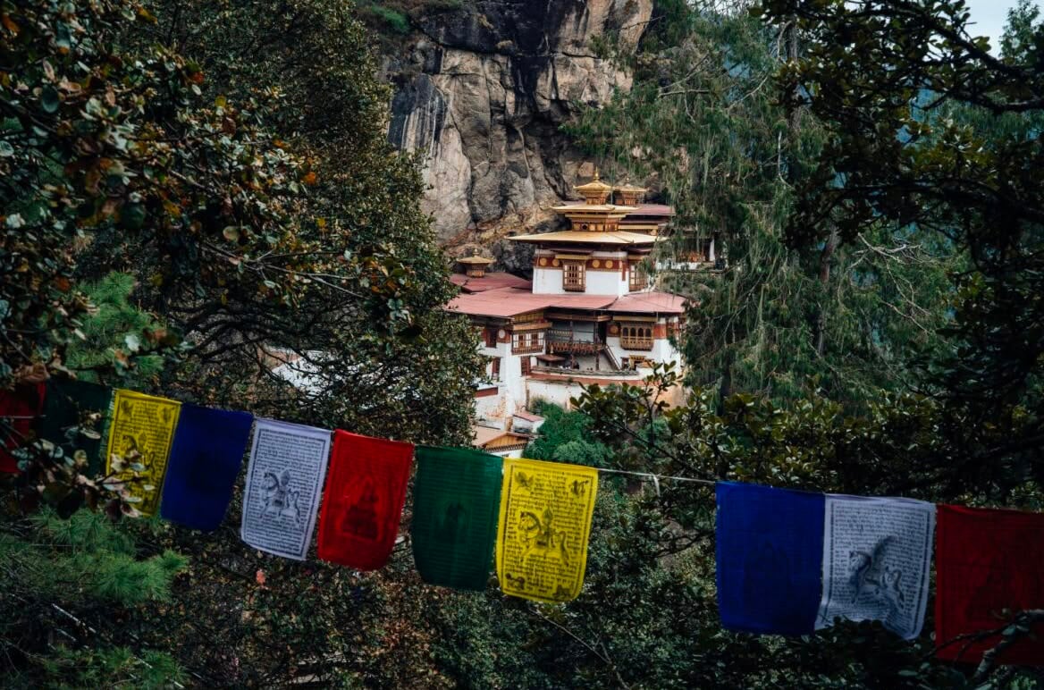 Tiger's Nest Through Colorful Prayer Flags
